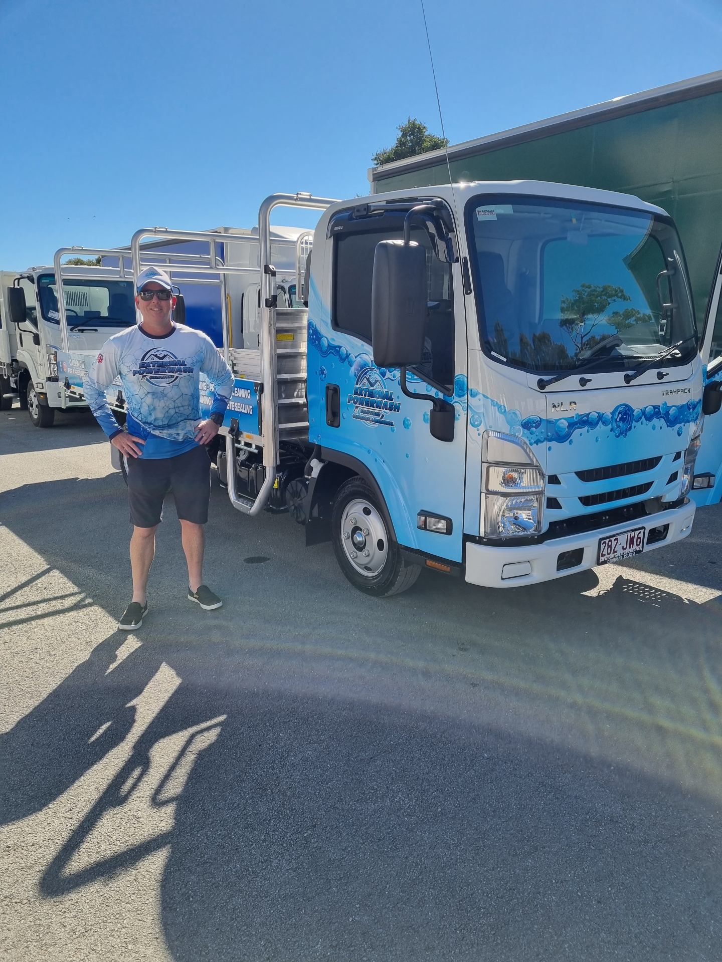 Grant from External Powerwash Solutions standing beside his fully equipped pressure washing truck in South East Queensland